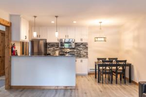 a kitchen with a counter and a table with chairs at One BDR in the Heart of Olympic Valley in Alpine Meadows