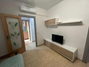 ein Wohnzimmer mit einem TV an der Wand in der Unterkunft Casa Maria in Sant Carles de la Ràpita