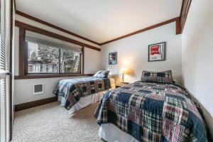 two beds in a room with a window at 4BD Lakeside Retreat with Views in Tahoe City