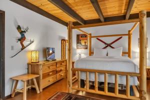 a bedroom with a bed and a wooden ceiling at 3BD Three Minutes from King Beach in Kings Beach
