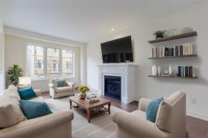 a living room with two couches and a fireplace at 4-Bedroom Serenity Retreat - Comfort & Style in Brampton