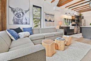 a living room with a couch and a kitchen at Stylish Downtown 2BD Walk to Chairlifts in Park City
