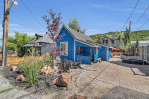 a blue house with a patio in a yard at Stylish Downtown 2BD Walk to Chairlifts in Park City