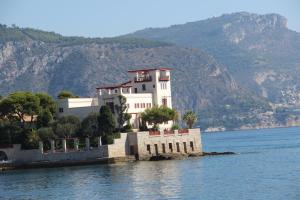 a house on a island in the middle of the water at Hôtel La Villa Patricia - Charme et Tradition in Villefranche-sur-Mer