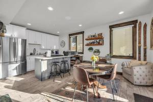 a kitchen and living room with a table and chairs at 2BD Near Slopes and Town with Impressive Views in Park City