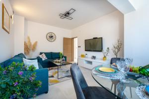 a living room with a couch and a table at Luxury Villa Ivona Pool, Jacuzzi, Sauna & Privacy in Ošlje
