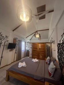 a bedroom with a large bed in a room at SASCHAS PLACE in Siquijor