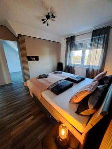 a bedroom with a large bed with a window at Haus Moor Merland in Moormerland