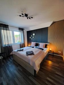 a bedroom with a large bed and a ceiling fan at Haus Moor Merland in Moormerland