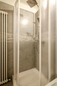 a shower with a glass door in a bathroom at Nosadella Studio in Bologna