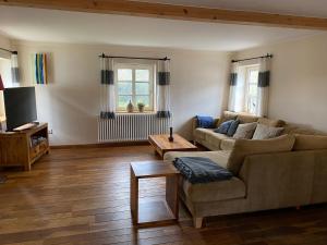 a living room with a couch and a table at Ferienhaus Wietsche in Burscheid