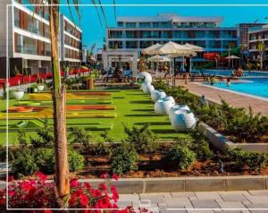a resort with a swimming pool and a resort at Comfy, Luxury Flat for All Ages in Iskele