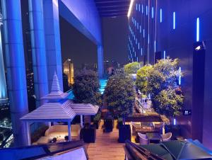 a view of a building with tables and trees at Platinum suites klcc by Fifty One in Kuala Lumpur