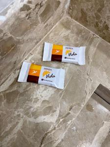 two packets of coffee sitting on a marble floor at Pousada Velho Brito in Piranhas
