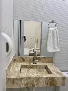 a bathroom with a marble sink and a mirror at Pousada Velho Brito in Piranhas +12 photos