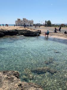 a group of people playing in the water at the beach at Bella Puglia Bed and Breakfast in Ruvo di Puglia