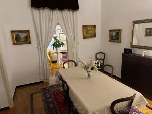 a dining room with a table with a vase of flowers on it at Interno 12 (140 mq) in Naples