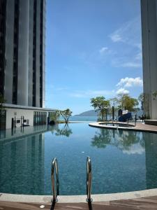 a swimming pool in the middle of a building at SummerSet Seaview Studio Apartment at Kota Kinabalu City Centre in Kota Kinabalu