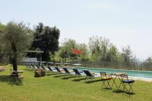 a row of chairs and tables next to a swimming pool at Ferienhaus mit Privatpool für 14 Personen ca 252 qm in Tresana, Toskana Provinz Massa-Carrara in Tresana