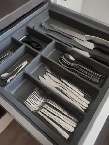 a drawer filled with silver utensils in a drawer at Wohnung Graz zentrale Lage in Graz
