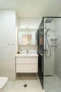 a bathroom with a sink and a shower at Apartment Alpic 204- Near Ski Lift - By Wehost in Gudauri