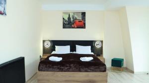 a bedroom with a large bed with two pillows at 1BR Apartment In Marshall Gudauri Project in Gudauri