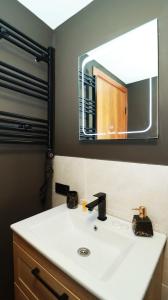 a bathroom with a sink and a mirror at 1BR Apartment In Marshall Gudauri Project in Gudauri