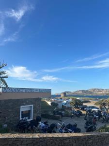 a group of motorcycles parked in a parking lot at Residence Hotel La Pelosetta in Stintino