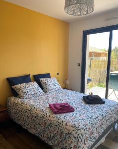 1 dormitorio con 1 cama con 2 toallas en Superbe Studio meublé idéal pour couple ZEN avec SPA en Sanguinet