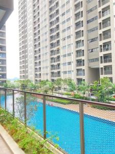 a view of a swimming pool with tall buildings at AYMAR Homestay, Youth City. in Nilai