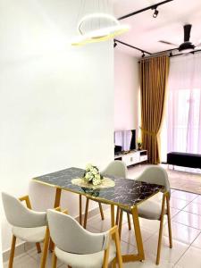 a dining room with a table and chairs at AYMAR Homestay, Youth City. in Nilai