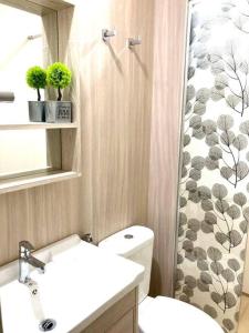 a bathroom with a toilet and a shower curtain at AYMAR Homestay, Youth City. in Nilai
