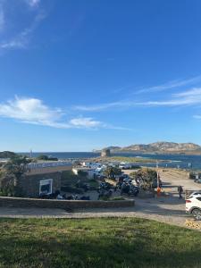 a view of a parking lot next to the ocean at Residence Hotel La Pelosetta in Stintino