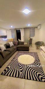 a living room with a zebra rug on the floor at Feels Like Home Condo Victoria Falls in Victoria Falls
