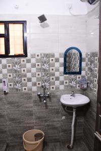 a bathroom with a sink and a mirror at Rivasa homes in Deoghar