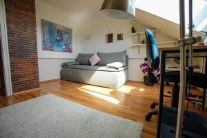 a living room with a couch and a brick wall at Stadtblick vom Herrengut in Baden-Baden