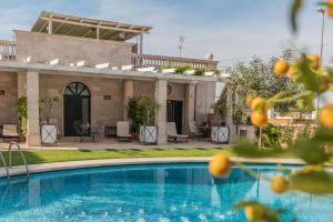a house with a swimming pool and a patio at Villa Caramia in Locorotondo