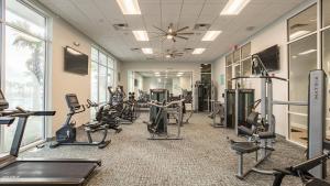 a gym with treadmills and cardio equipment in a building at Enchanted Villa in Orlando