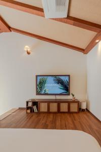a living room with a flat screen tv on a wall at Le Village Aewol G in Jeju