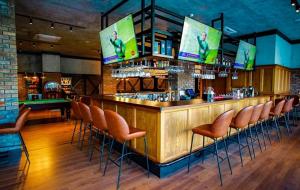a bar with orange stools at a bar with a billiard at Comfy, Luxury Flat for All Ages in Iskele
