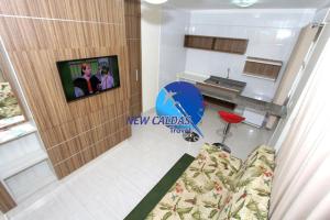 a view of a living room with a couch and a kitchen at Lacqua Diroma Flat - Oficial in Caldas Novas +44 photos