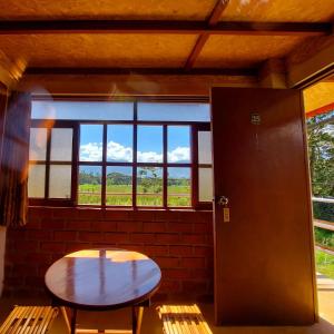 einen Tisch und Stühle in einem Zimmer mit Fenster in der Unterkunft Casa Hospedaje el Prado Eco turismo in Oxapampa