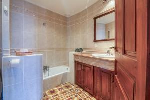 a bathroom with a tub and a sink and a mirror at Casa Lola Callosa 10 in Callosa de Ensarriá +51 photos