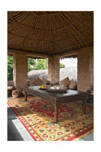 a table in the middle of a room with a rug at Manvār Shergarh , The Desert Resort in Dechu