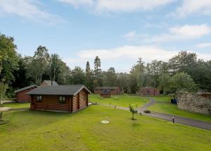 a cabin in the middle of a grassy field at Gadgirth Estate Lodges in Annbank
