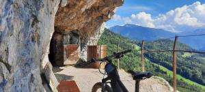 a bike parked on a cliff with a view at Hexenhäuschen in Bad Goisern