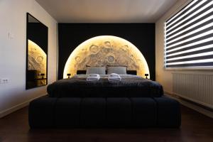 ein Schlafzimmer mit einem Bett mit einer großen Kugel an der Wand in der Unterkunft Moonlight Studio in Pristina