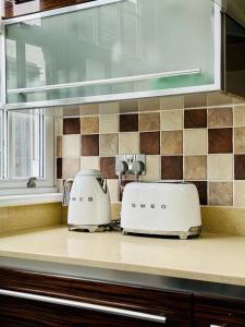 two toasters sitting on a counter in a kitchen at ROBERT HOUSE in London