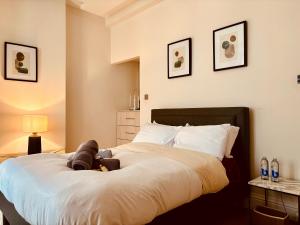 a bedroom with a large bed with a teddy bear on it at ROBERT HOUSE in London