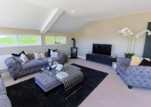 a large living room with couches and a tv at Heads Of Ayr Holiday Park in Ayr